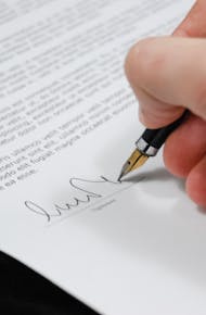 Person Signing in Documentation Paper